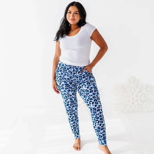 Woman wearing blue leopard print leggings and a white t-shirt on a white background