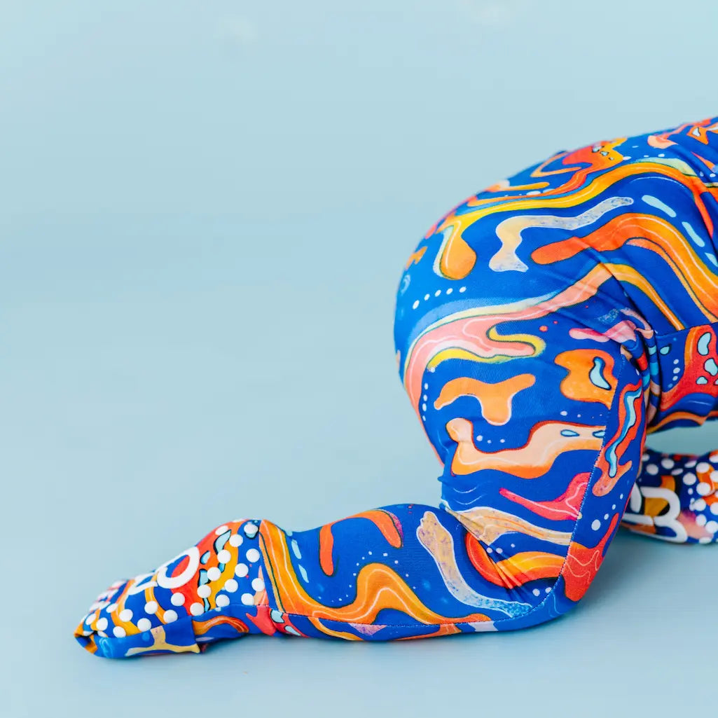 Colorful abstract patterned legs on a light blue background