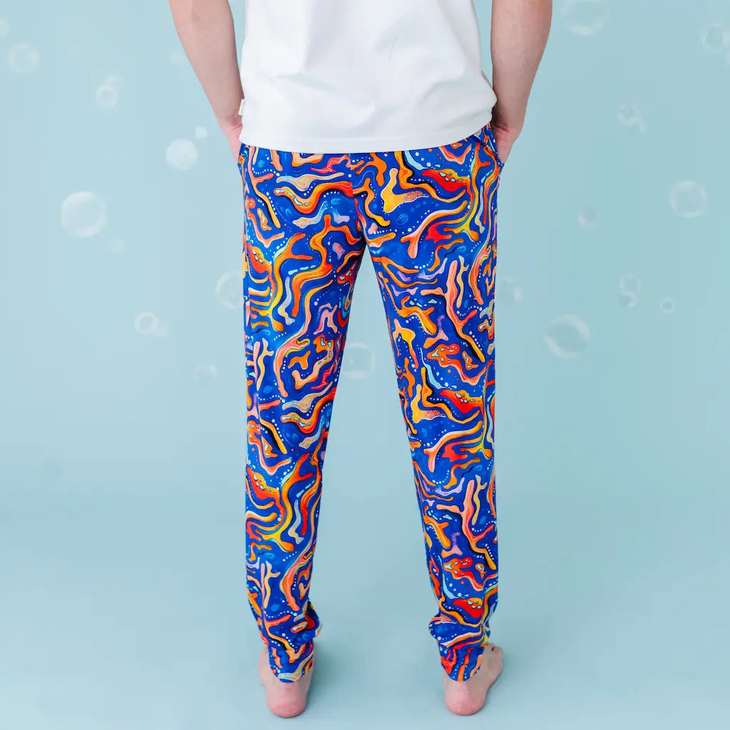 Colorful abstract patterned leggings worn by a person on a blue background.