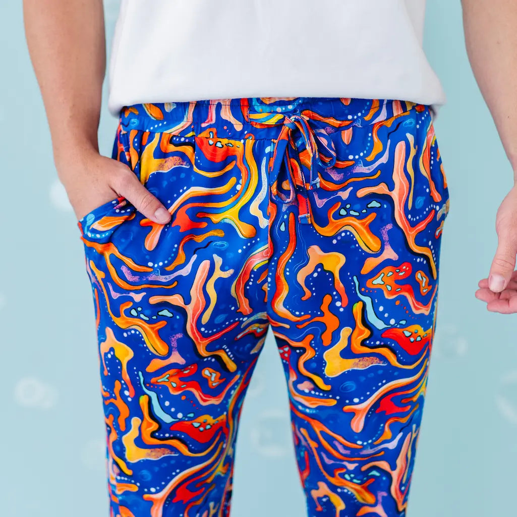 Colorful abstract patterned pants worn by a person.