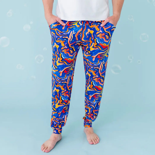 Colorful abstract-patterned leggings worn by a person on a light blue background.
