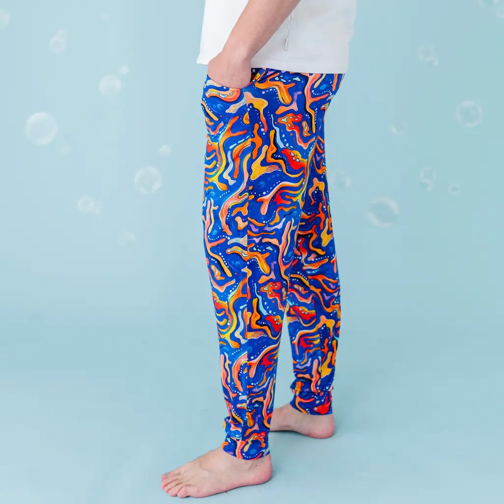 Colorful abstract-patterned leggings on a person against a light blue background.
