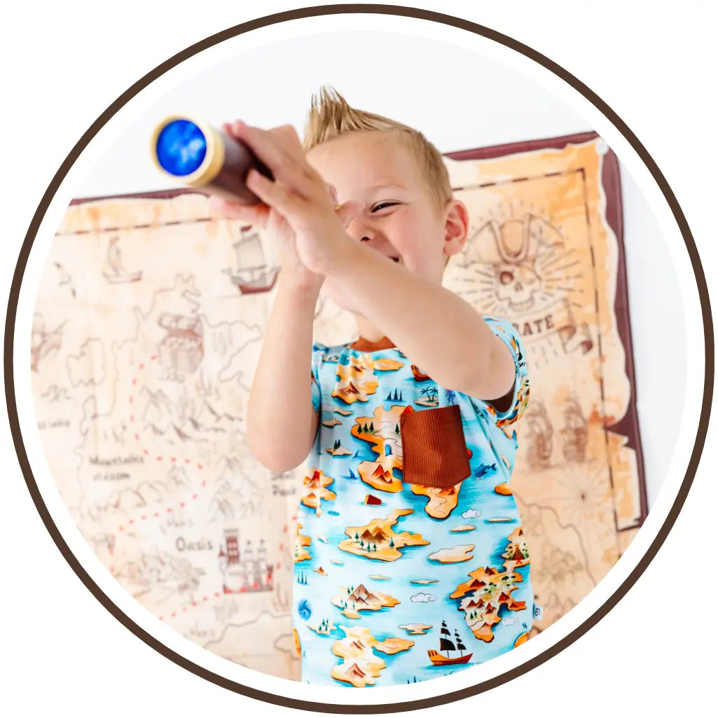 Child playing with a toy telescope in front of a map