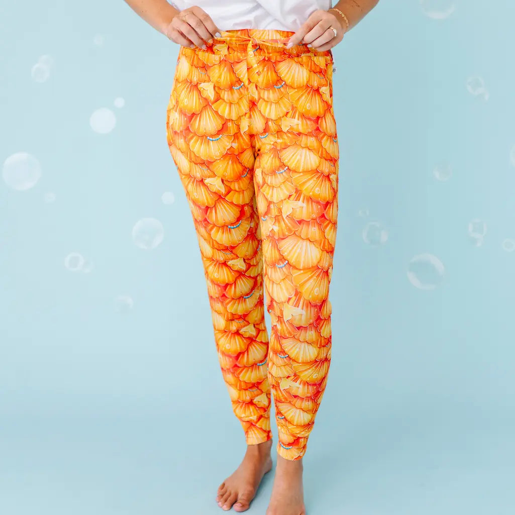 Orange leggings with leaf pattern on a light blue background