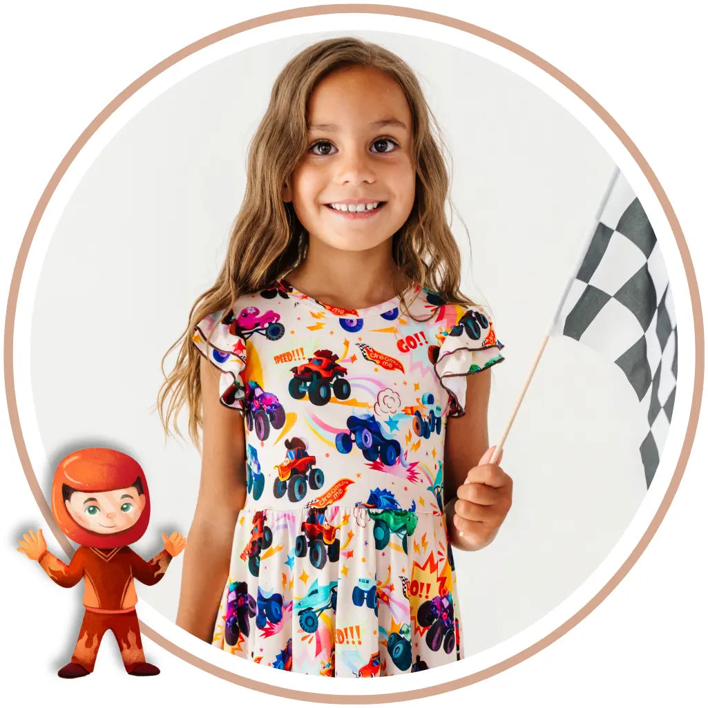 Circular tile of a smiling child in a monster truck print dress holding a checkered flag, with a small racer character illustration.