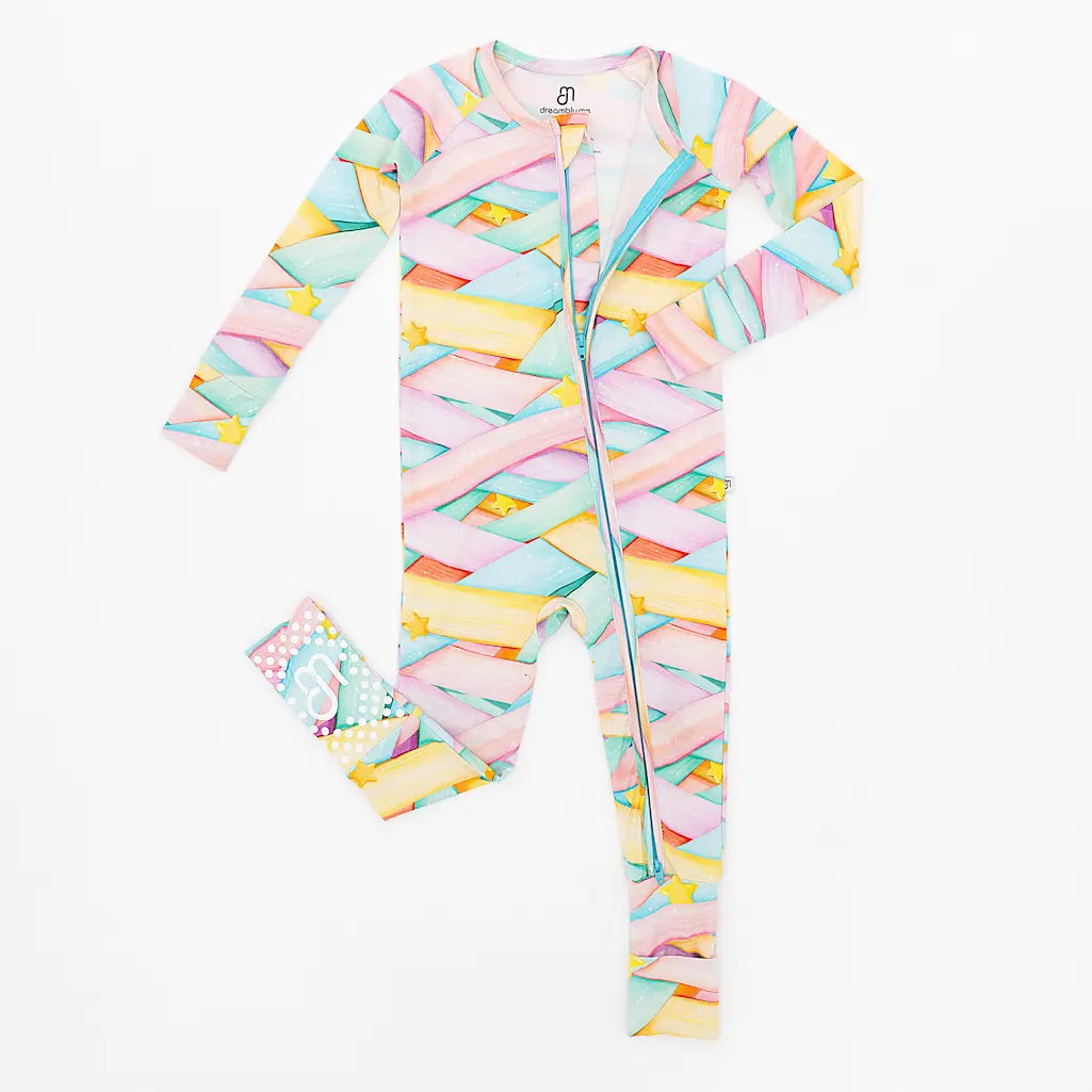 Colorful pastel-patterned baby onesie with long sleeves and a matching headband displayed on a white background