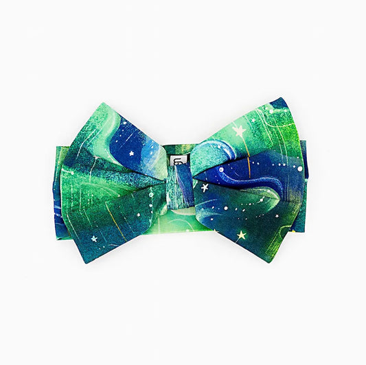 Bow tie featuring a green and blue space-themed design with stars, displayed on a white background