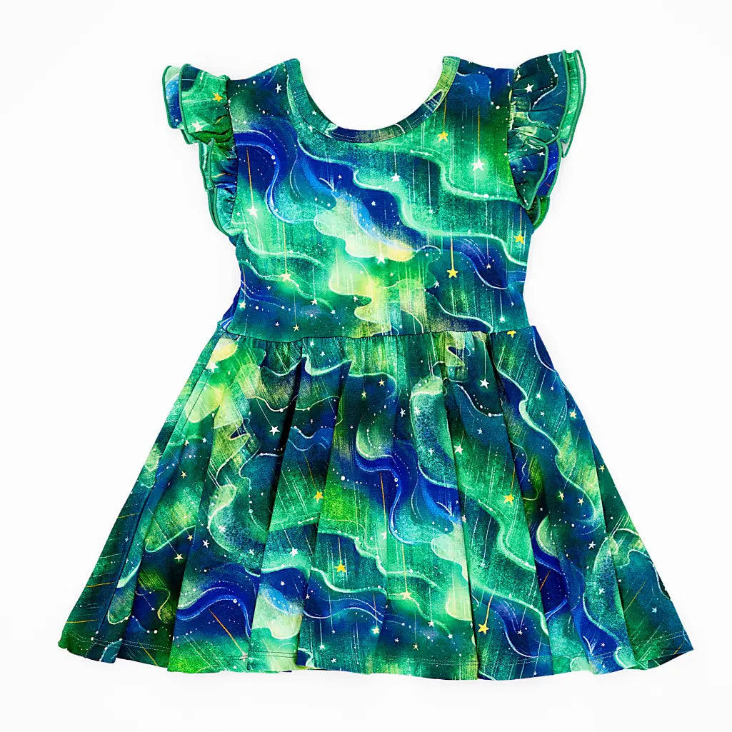 Green and blue dress with celestial pattern on a white background