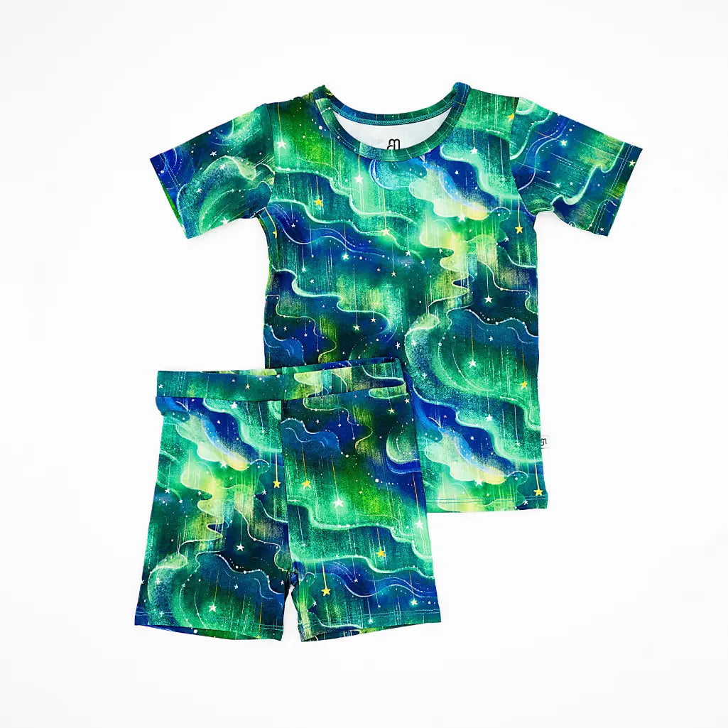 Children's t-shirt and shorts set with green and blue abstract pattern on a white background