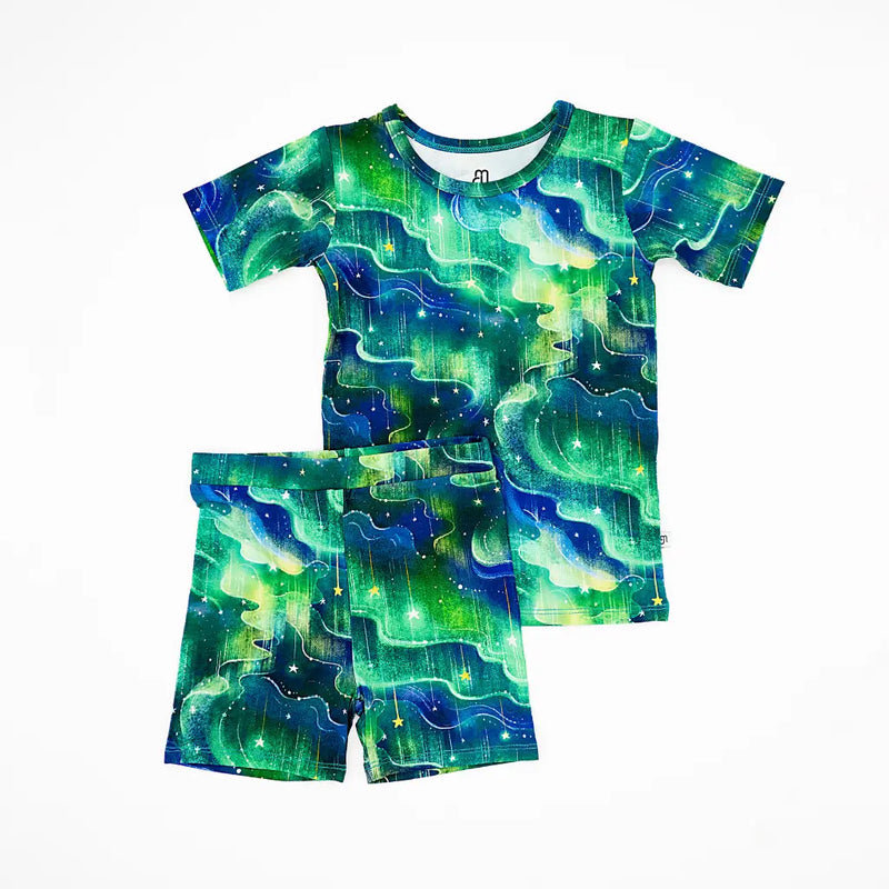 Children's t-shirt and shorts set with green and blue abstract pattern on a white background