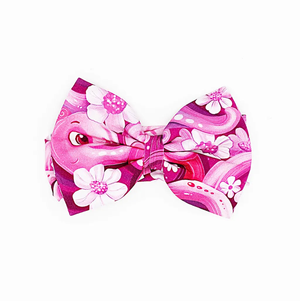 A pink headband with a pattern of swirling tentacles and white flowers.