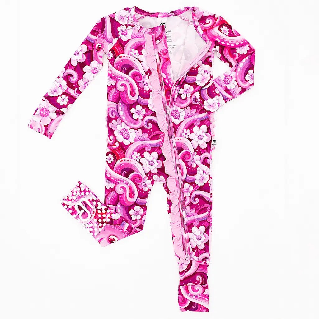 A one-piece zipper pajama for babies with a playful pink octopus and white flower pattern, including convertible foot covers and fold-over mittens.