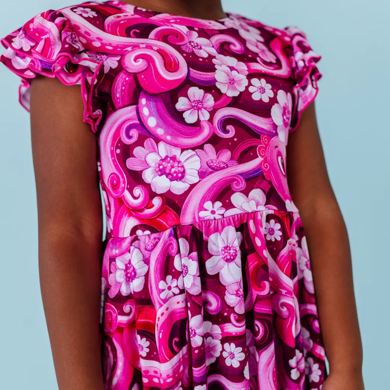 Pink and white floral dress with ruffled sleeves on a light blue background