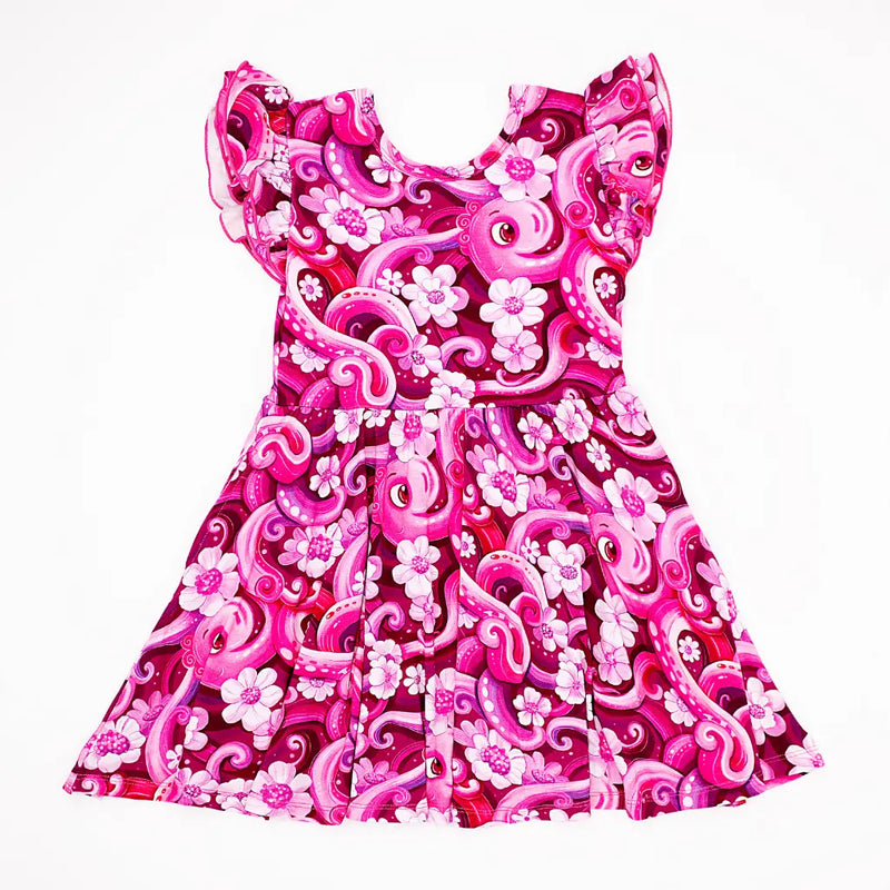 Pink dress with floral and swirl patterns on a white background