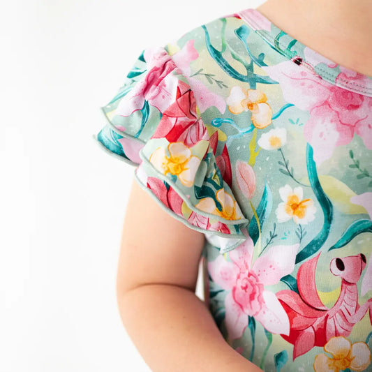 Colorful floral-patterned shorts on a child against a white background
