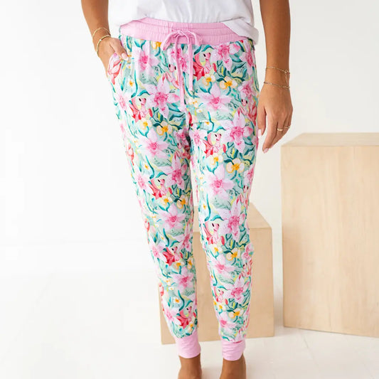 Floral patterned pants worn by a person on a white background
