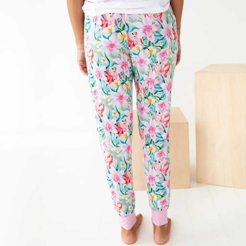 Floral patterned pants worn by a person on a white background