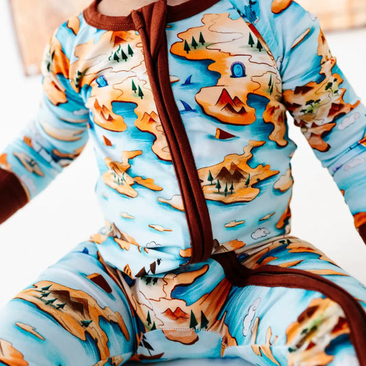 Children's onesie with a nature-themed design on a plain background