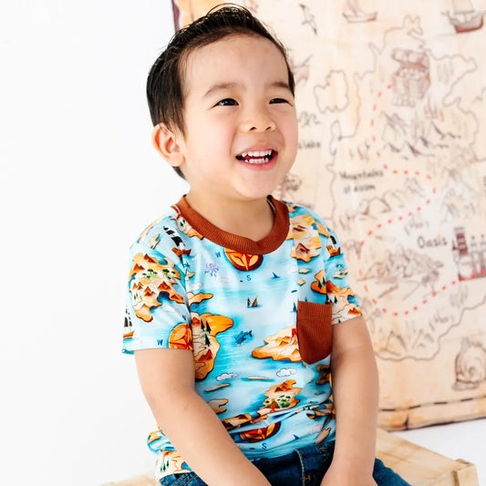 Child wearing a colorful shirt with a map background