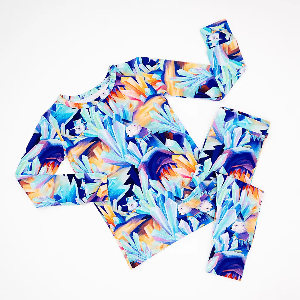 Colorful geometric-patterned top and leggings set on a white background