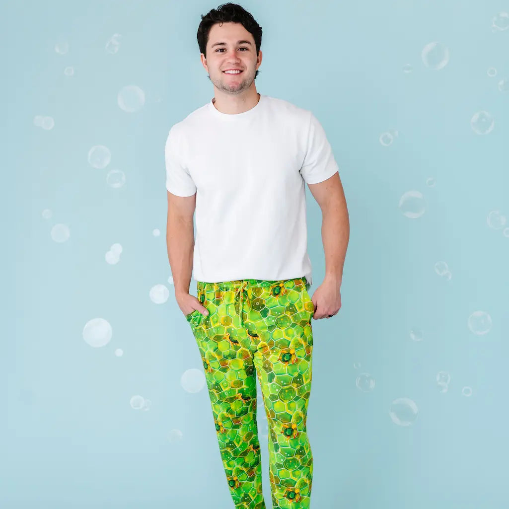 Person wearing green patterned pants on a blue background
