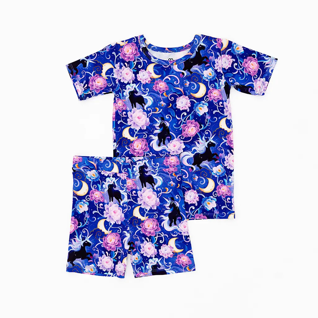 Children's pajama set with cat and moon design on a blue background