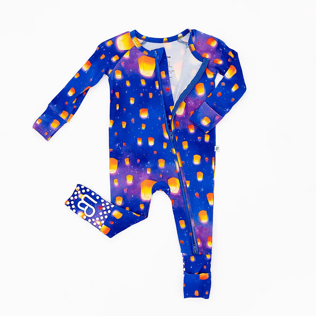 Colorful baby onesie with a matching hat on a white background