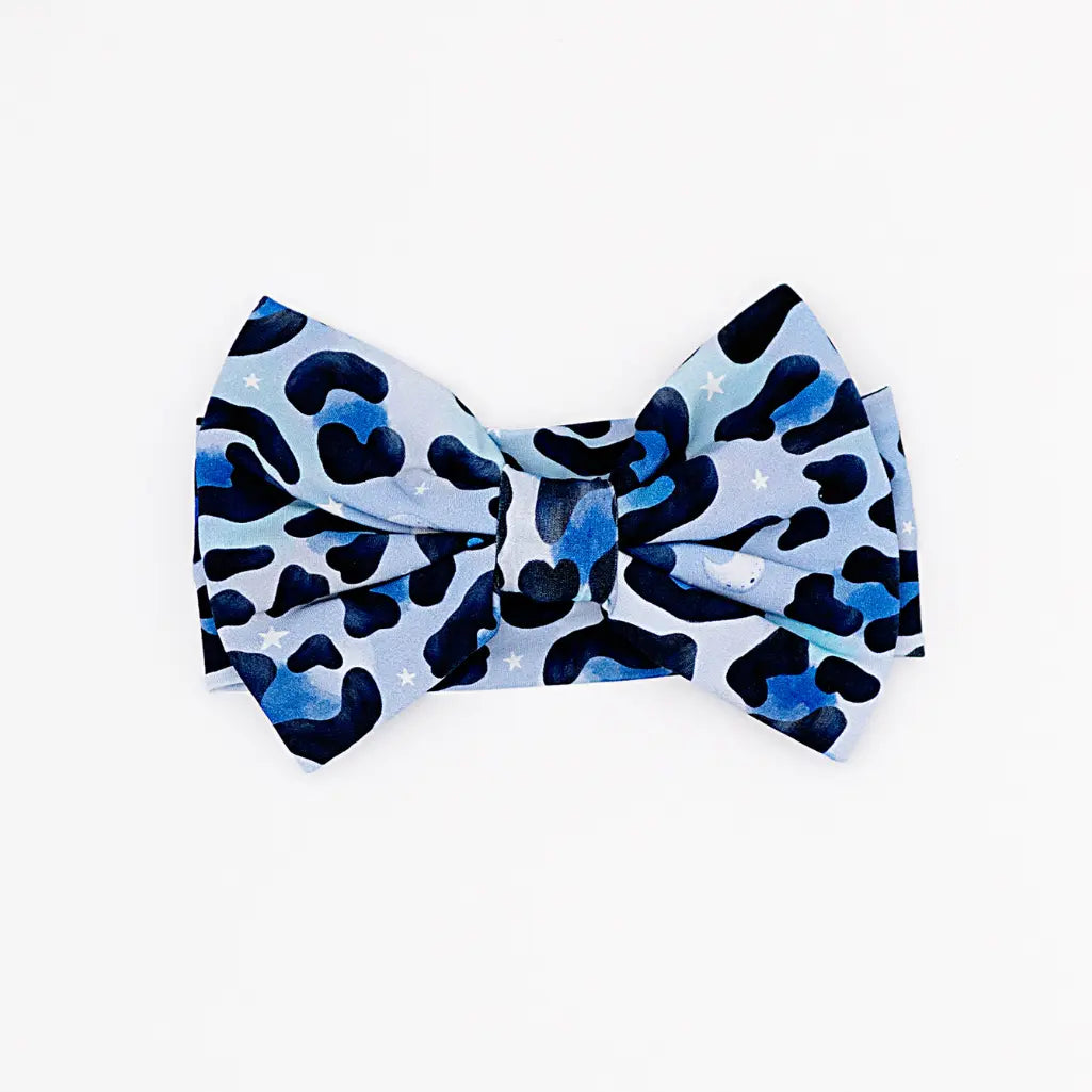 Blue and black patterned bow tie on a white background