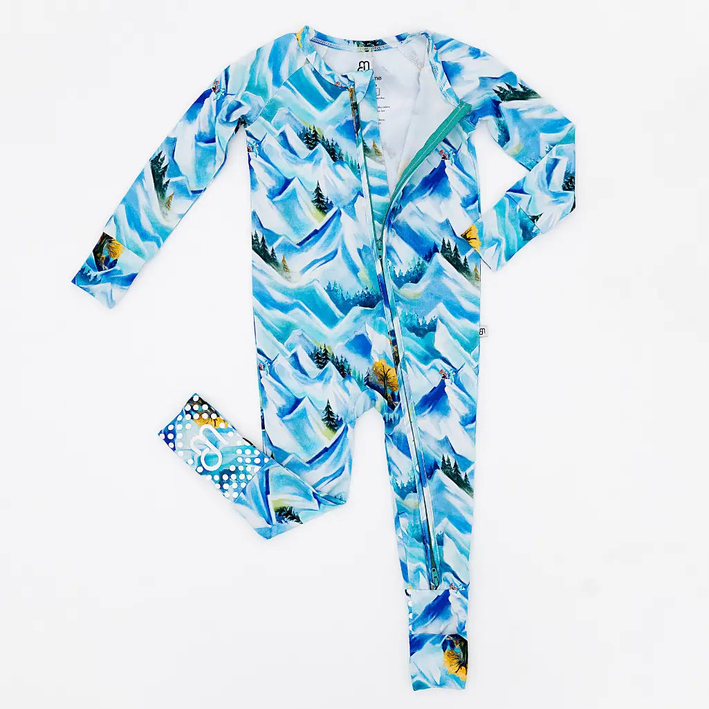 Children's onesie with mountain and tree pattern on a white background