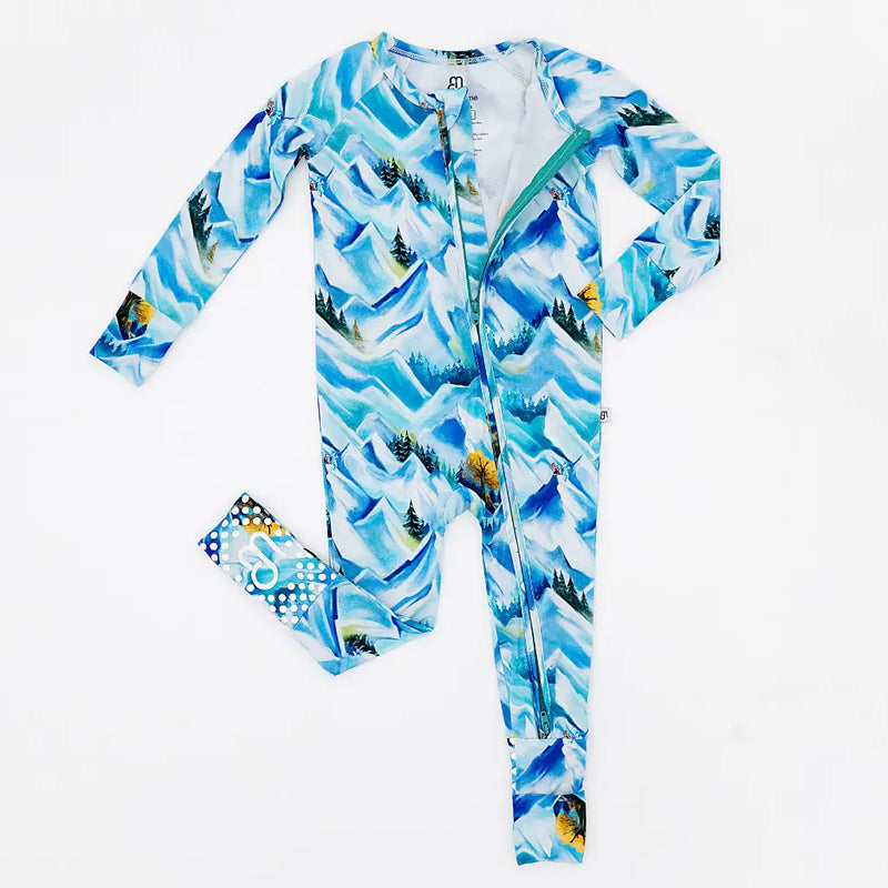 Children's onesie with mountain and tree pattern on a white background