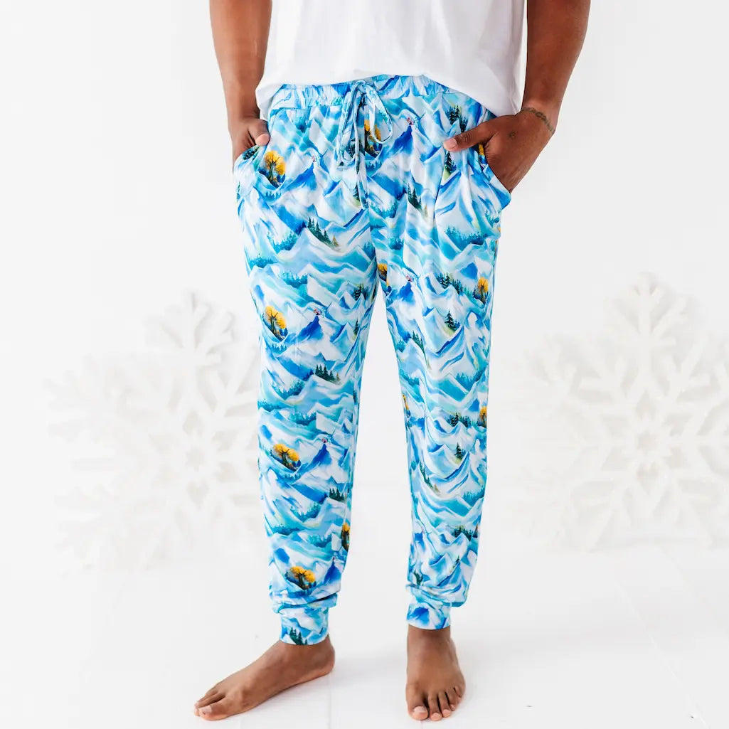 Blue patterned pants worn by a person on a white background