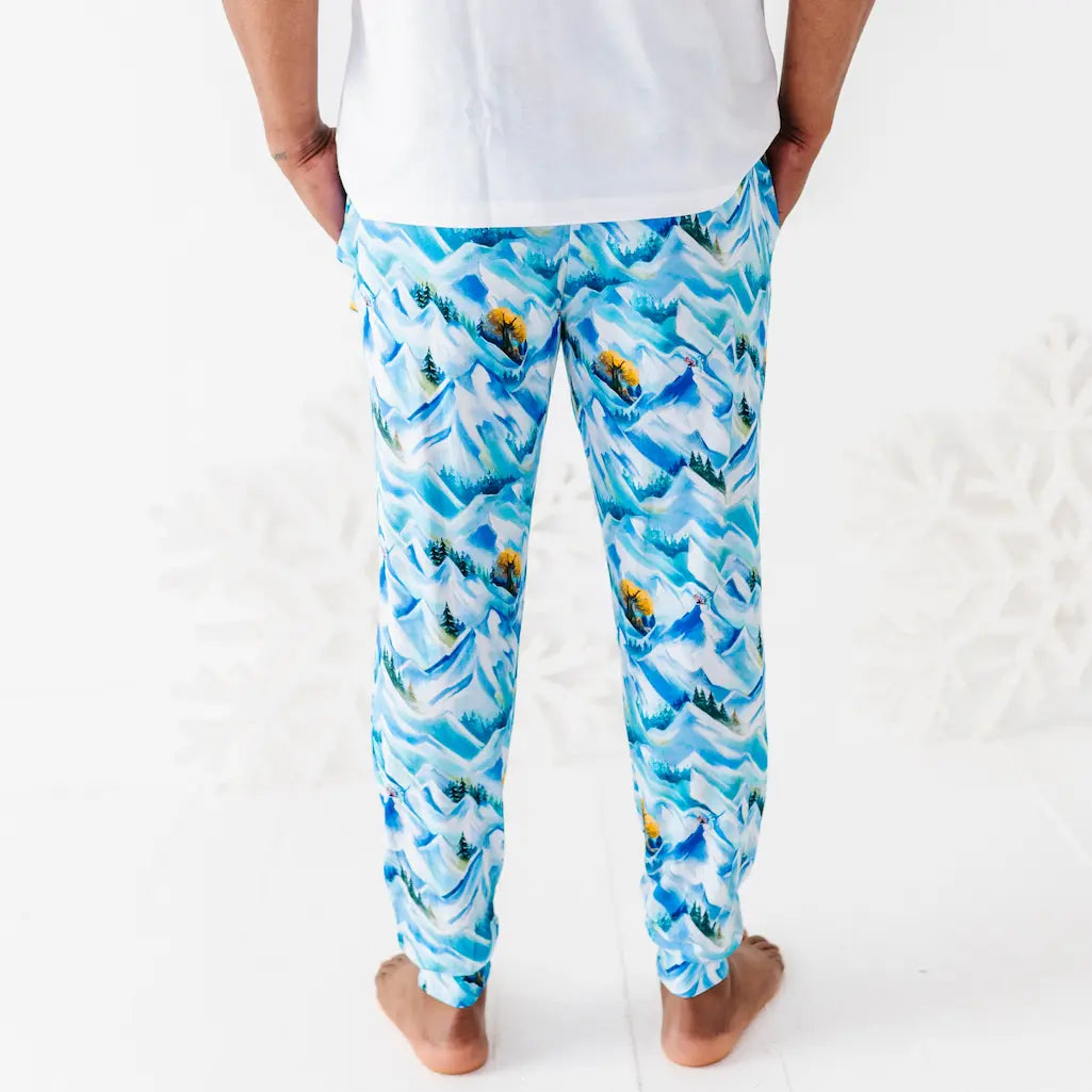 Person wearing blue patterned pajama pants on a white background