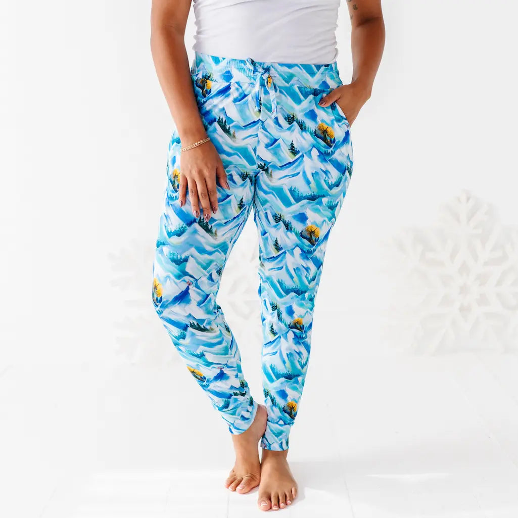 Person wearing blue shark print pants on a white background