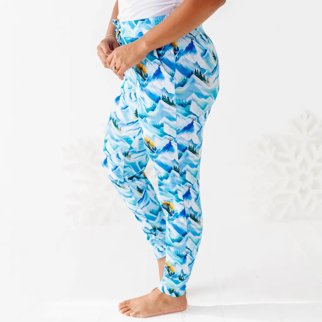 Blue patterned pants worn by a person on a white background