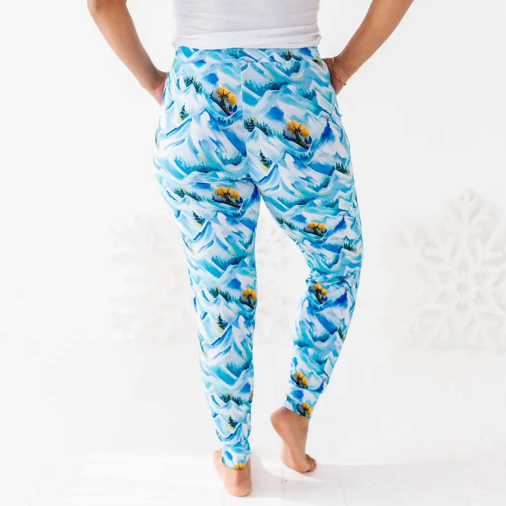 Person wearing blue patterned leggings on a white background