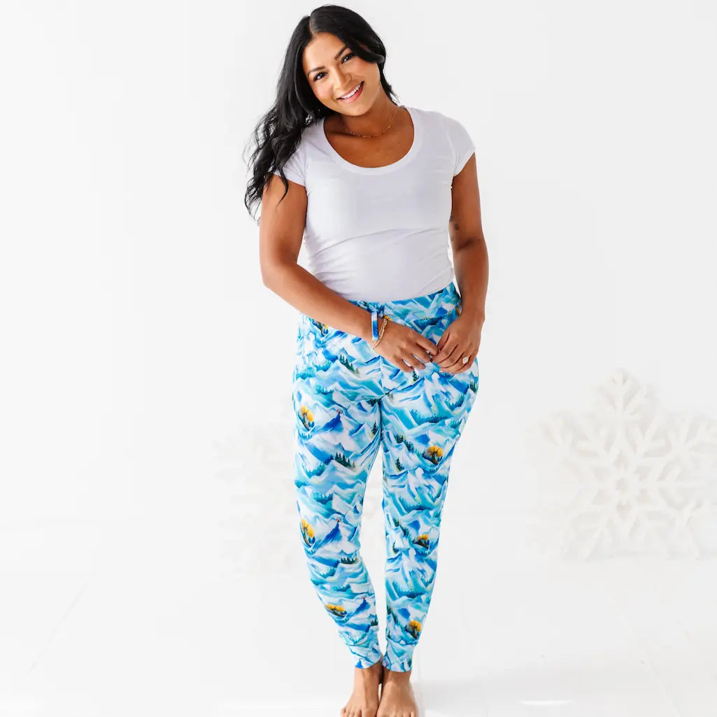 Woman wearing a white top and blue patterned pants on a white background