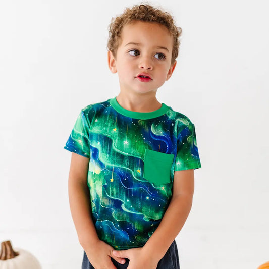 Child wearing a green and blue patterned shirt on a white background