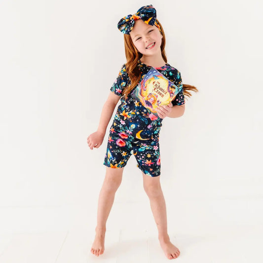 Child wearing a colorful swimsuit with a white background