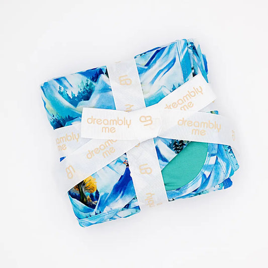 Blue and green patterned fabric with 'dreamily me' labels on a white background
