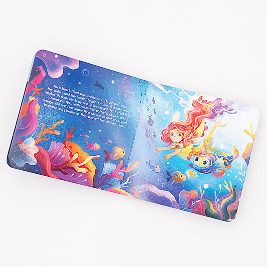 Illustrated children's storybook spread showing a mermaid girl swimming with colorful fish and sea creatures in an underwater ocean scene