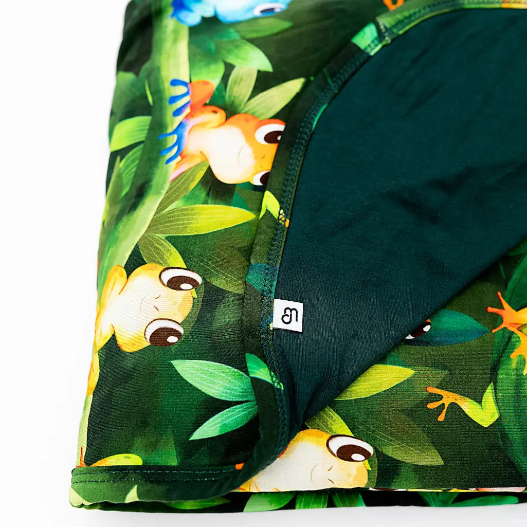 Green shorts with a colorful frog pattern on a white background