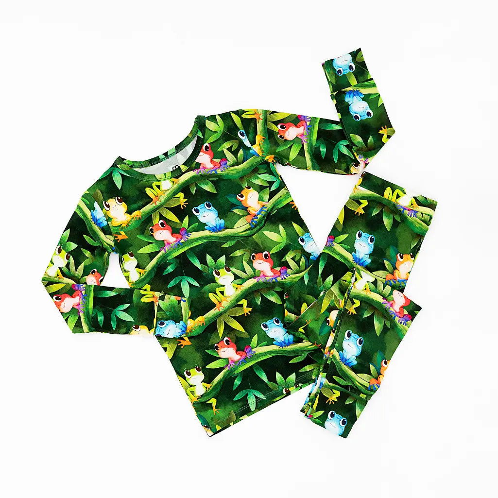 Children's outfit with frog and leaf pattern on a white background
