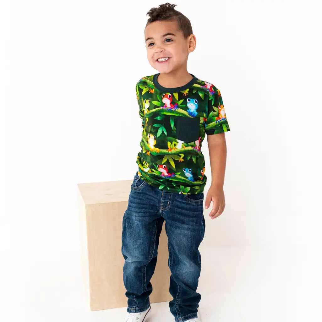 Child wearing a colorful t-shirt with animal prints on a white background