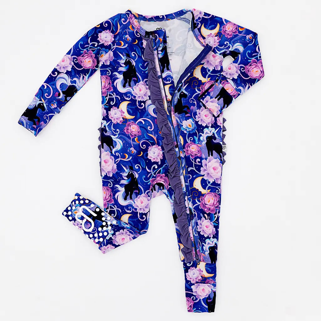 Colorful baby onesie with floral and cat pattern on a white background