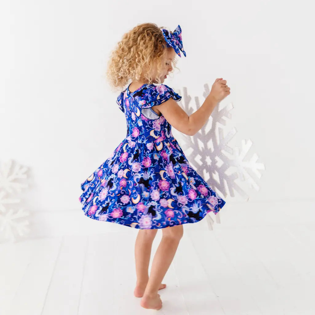 Child wearing a floral dress with a white background