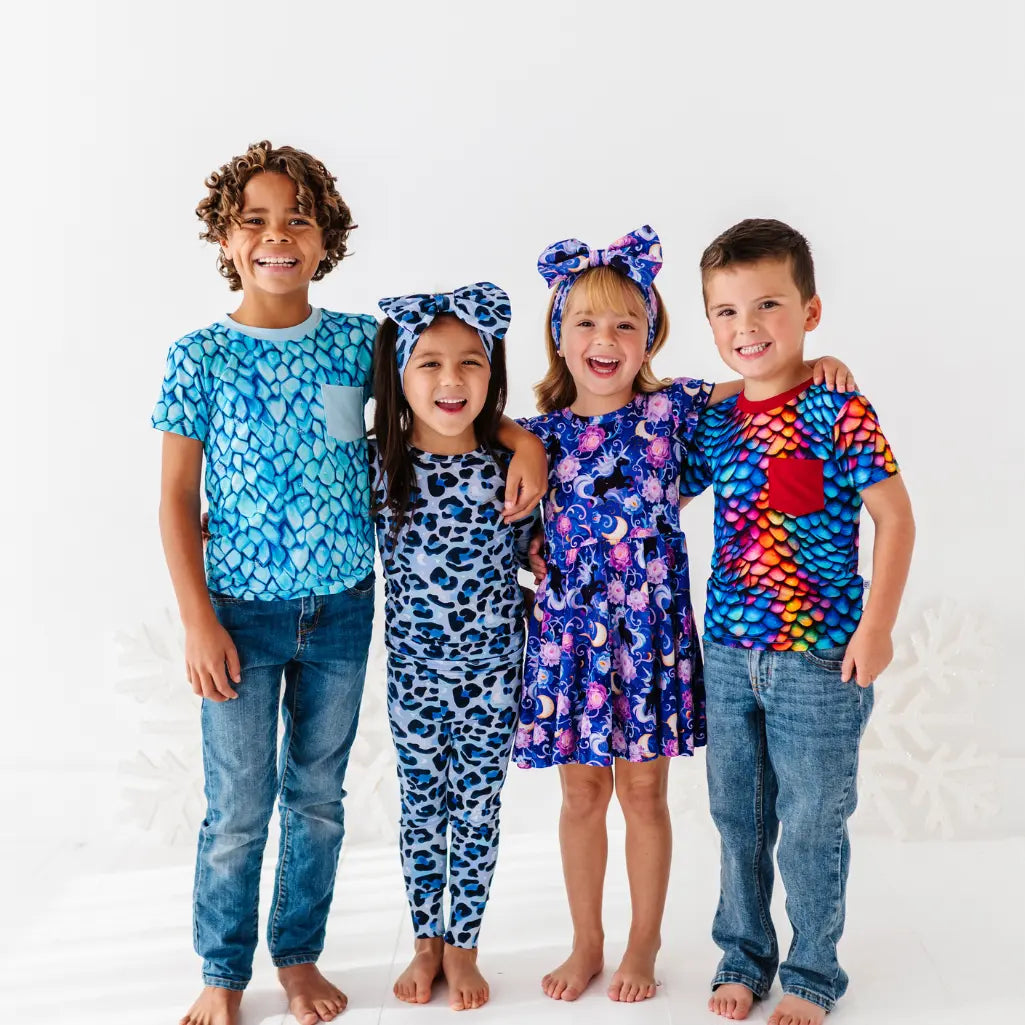 Four children wearing colorful pajamas on a white background