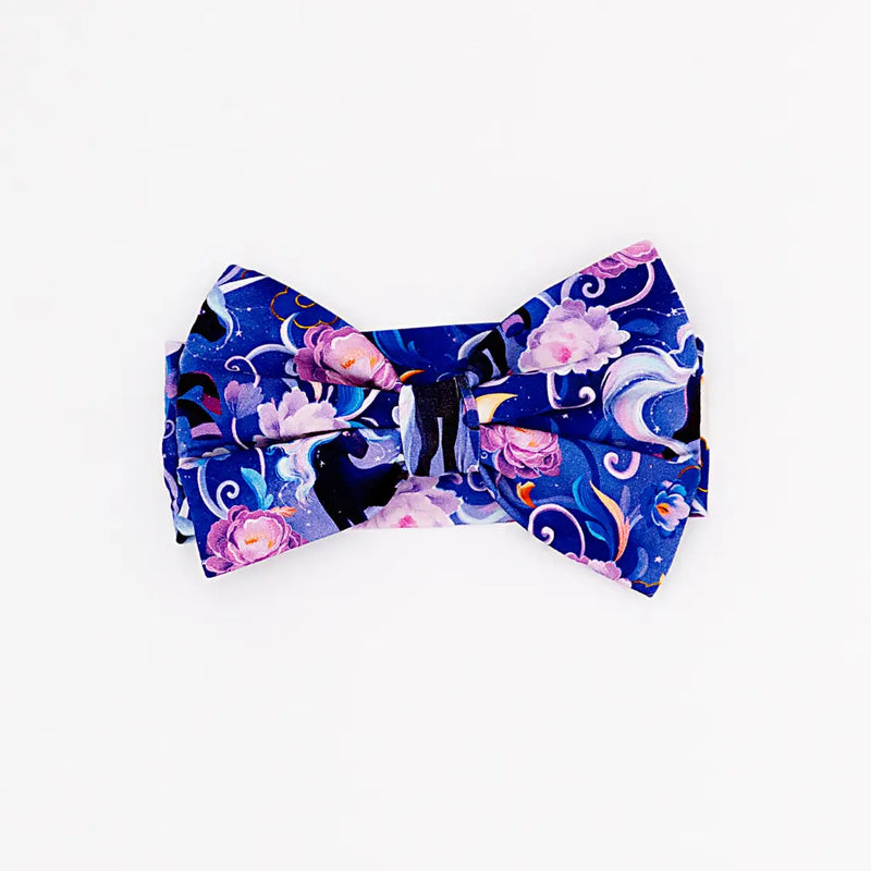Floral and moon-themed bow tie on a white background