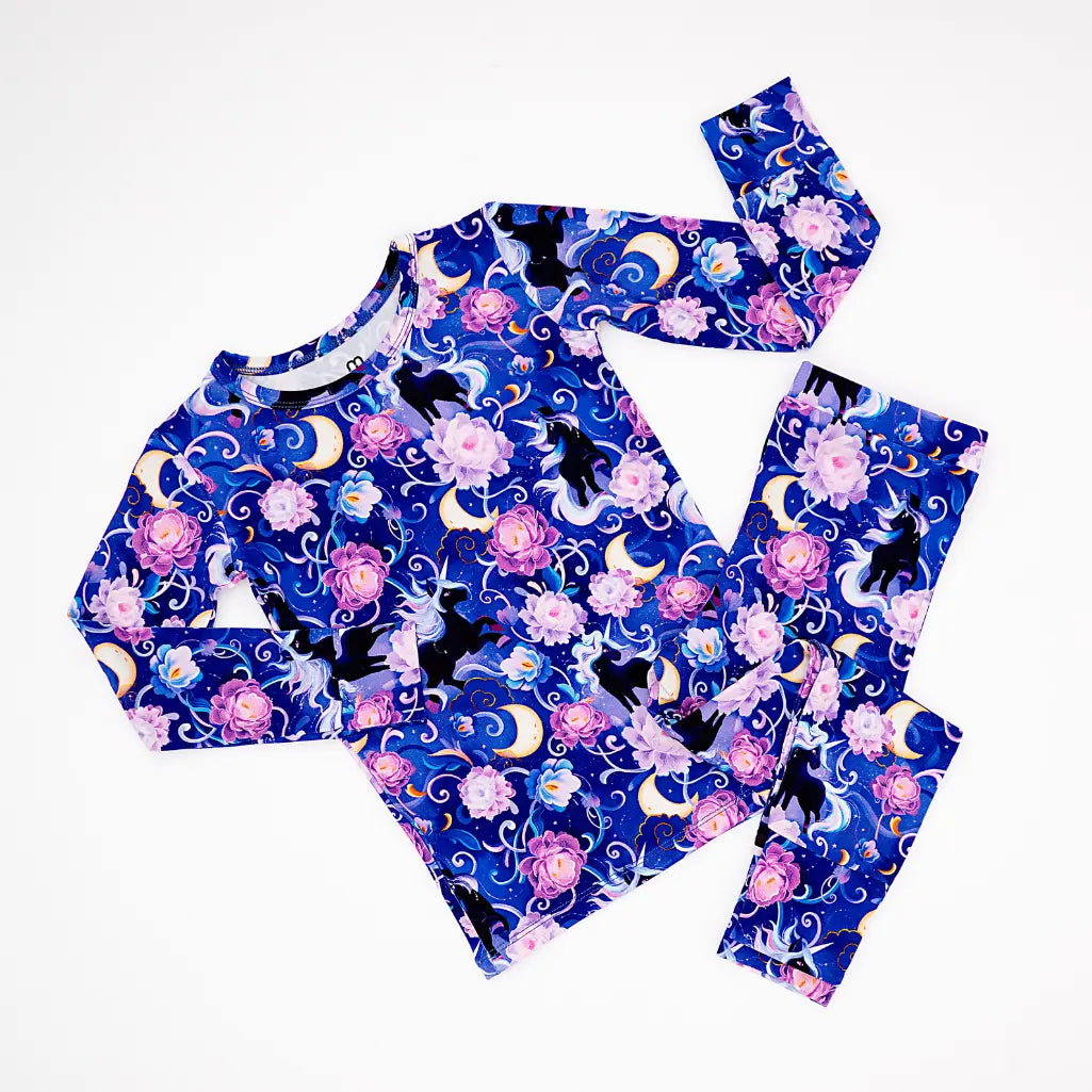 Children's pajama set with cat and moon design on a white background