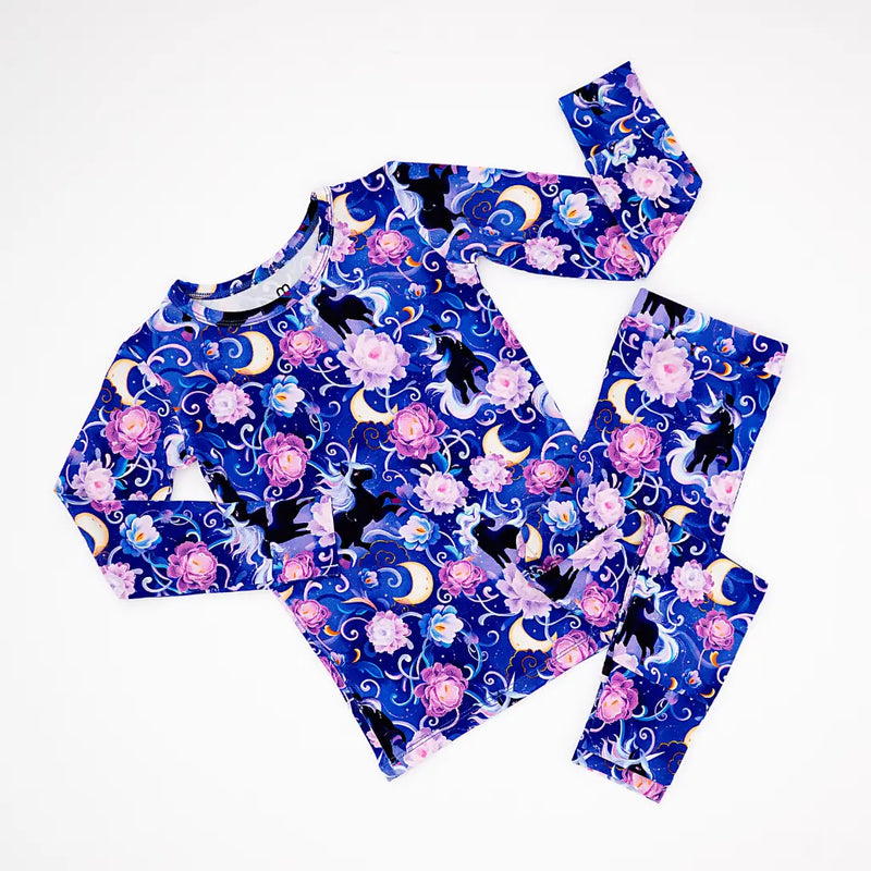 Children's pajama set with cat and moon design on a white background