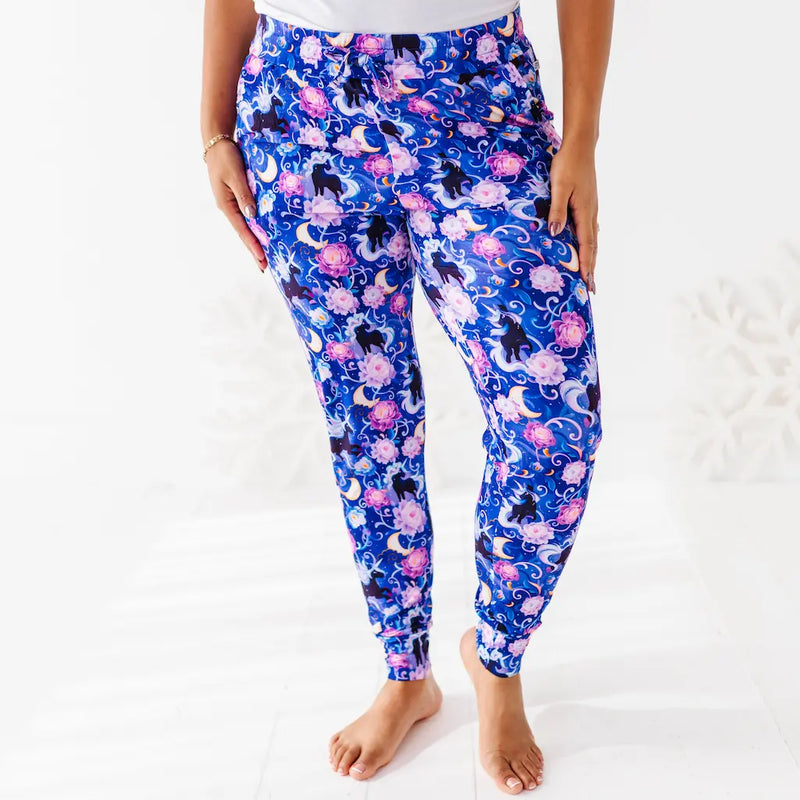 Person wearing blue floral leggings on a white background